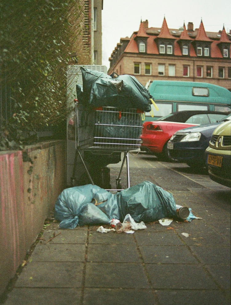 Picture of Shopping Cart on Sidewalk full of Trash Bags